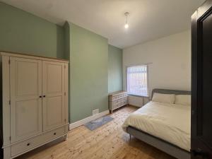 a bedroom with a bed and a cabinet and a window at Crosby & Waterloo Beachside Stay in Waterloo