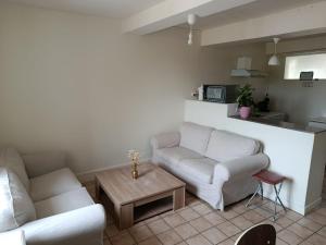 a living room with two couches and a coffee table at Maison Charton in Château-Chinon