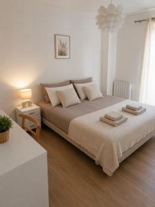 a bedroom with a large bed with two towels on it at Maison Charton in Château-Chinon