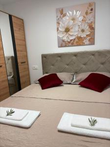 a bedroom with a bed with two towels on it at Apartmani Đurišić in Posušje