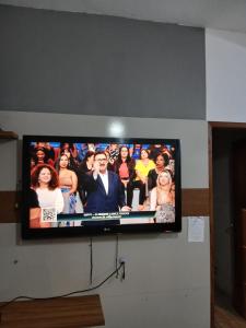 a flat screen tv hanging on a wall at Kiko Schettino in Angra dos Reis