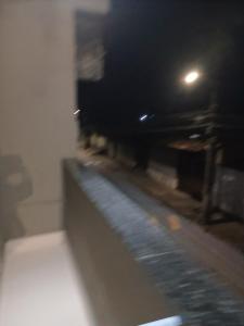 a blurry picture of a street at night at Kiko Schettino in Angra dos Reis +2 photos