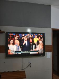 a flat screen tv hanging on a wall at Kiko Schettino in Angra dos Reis