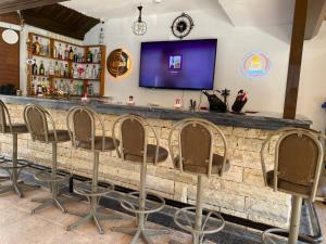 a bar with chairs lined up against a stone wall at ÖZ-AY APART OTEL in Marmaris