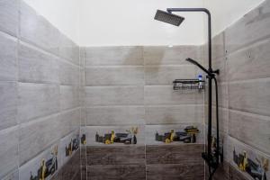 a bathroom with a shower with workers in it at oasis house in Takchrirt
