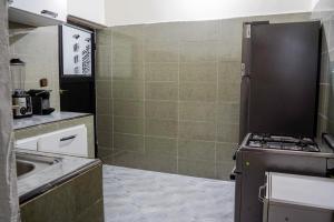 a small kitchen with a sink and a stove at oasis house in Takchrirt
