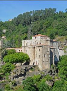 a castle on top of a mountain at Le chalet d'Agathe in Largentière +17 photos