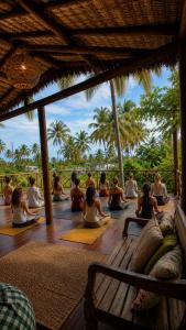 a group of people doing yoga on a deck at Serena Pousada - Icaraí de Amontada in Icaraí