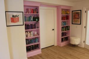 a room with pink book shelves filled with books at Waterfront Boutique Accommodation in PEC - Suite 3 in Belleville