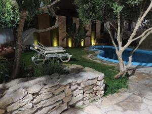 a couple of benches sitting next to a swimming pool at North Wind House in Peniche