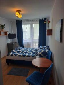a bedroom with a bed and a table and a window at Pokoje gościnne u Aleksandry in Hel +20 photos
