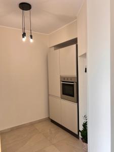 a kitchen with a refrigerator and a stove at Zen Apartment in Santa Maria del Cedro