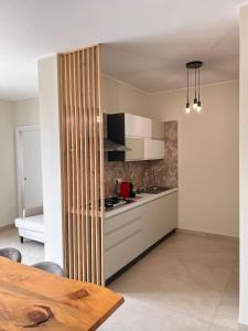 a kitchen with white cabinets and a stove top oven at Zen Apartment in Santa Maria del Cedro