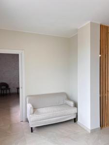 a white couch sitting in a living room at Zen Apartment in Santa Maria del Cedro +6 photos