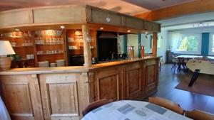 a large wooden bar in a room with a table at Les2Châteaux in Windstein