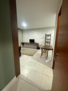 a living room with a chair and a table at Residencial DOM in Lorena