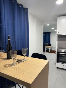 a table with two glasses and a bottle of wine at Wellness apartment Karlštejn in Karlštejn