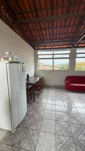 a living room with a table and a refrigerator at downtown Teófilo Otoni in Teófilo Otoni