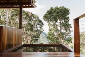 a view from the deck of a house in the forest at Recanto Bougainville ST in Santa Teresa