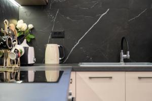 a kitchen with a counter top with a sink and a counter top at Thalori villa 1 in Psalidi +41 photos