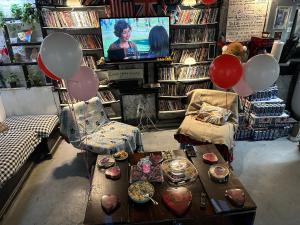 a living room with balloons and a table and a tv at the Brooklyn Riviera in Brooklyn +7 photos