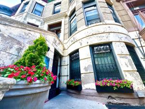 a house with flowers in front of a building at the Brooklyn Riviera in Brooklyn