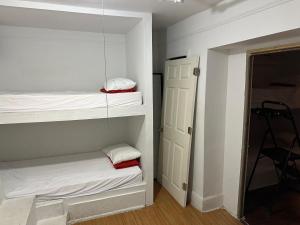 a room with two bunk beds and a door at the Brooklyn Riviera in Brooklyn
