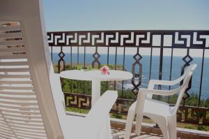a table and two chairs on a balcony with the ocean at Apart Hotel Apolonia Palace in Sinemorets
