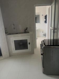 a white kitchen with a sink and a stove at RESIDENCE ADSL Studio BOUYGUES in Dakar +72 photos