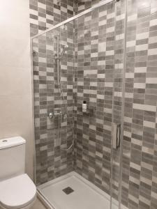 a bathroom with a shower with a toilet at Sliema central apartment in Sliema +12 photos