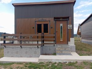a small building with a bench in front of it at Četiri sestre in Žabljak +2 photos