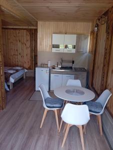 a kitchen and dining room with a table and chairs at Četiri sestre in Žabljak