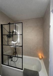a bathroom with a bath tub with a candle at Studio hesperides in Balaruc-les-Bains