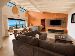 a living room with a couch and a table at Kaz mer veille in Les Avirons