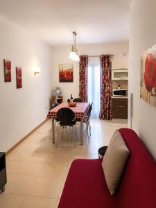 a living room with a table and a dining room at Sliema central apartment in Sliema