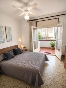 a bedroom with a bed and a ceiling fan at AMALIA 1 in L'Escala