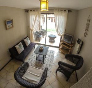 a living room with a couch and chairs and a table at Apart Hotel Gran Pacifico in La Serena