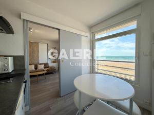 a kitchen and dining room with a view of the beach at GC - Au Large - Front de Mer in Wissant