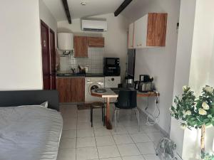 a small kitchen with a table in a room at Cosy house studio in Saint-Aunès