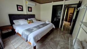a bedroom with a large bed in a room at Arboleda House by the River, Forest with Jacuzzi and A C in San Francisco