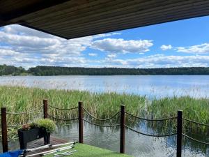 a view of a lake from a house with a net at Houseboat Przystań Spokoju in Ślesin