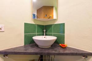 a bathroom with a sink and a mirror on the wall at Farm & Chill Guesthouse in Thierrens +12 photos