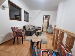 a living room with a couch and chairs at Kuća za odmor Lavanda in Sirogojno