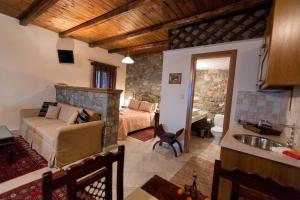 a living room with a couch and a bed in a room at Althaia in Ano Chora
