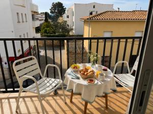 a table with a bowl of fruit on a balcony at AMALIA 1 in L'Escala