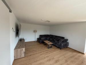 a living room with a couch and a table at Strandhaus Störtebeker in Koserow