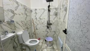 a bathroom with a toilet and a sink at Beldi apparemment in Imlil