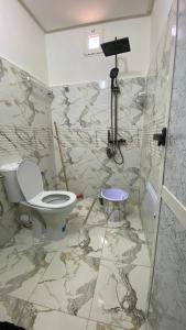a bathroom with a toilet and a camera at Beldi apparemment in Imlil