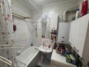 a bathroom with a sink and a bath tub at Egry Rooms in Veszprém +34 photos