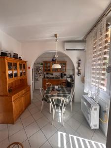 a kitchen and dining room with a table and chairs at Egry Rooms in Veszprém